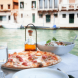 Pizza at a restaurant in Italy overlooking a canal in Venice