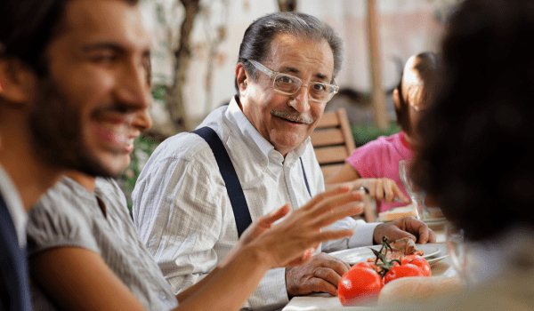 An older Italian man smiling at a lady