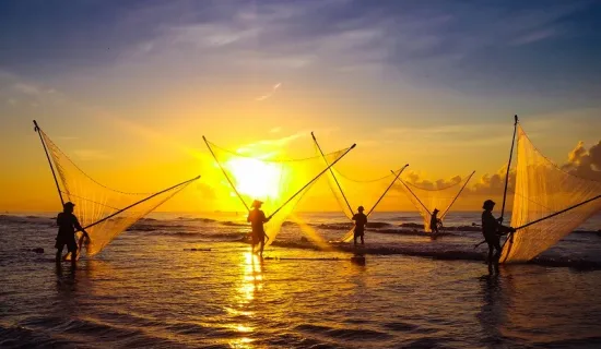 Fishermen fishing in the sea at sunrise in Namdinh, Vietnam